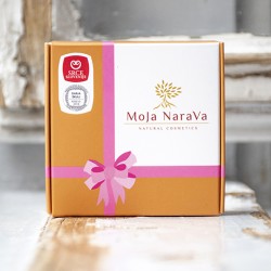 Moja Narava gift box packaging with pink ribbon graphic, product photo on rustic background