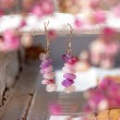 Lepidolite chip bead earrings hanging, pink and purple tones with blurred floral background