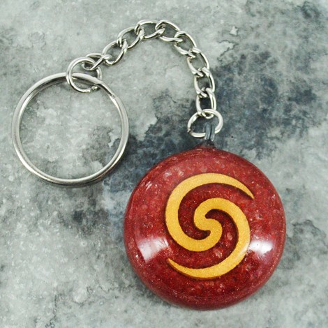 Orgonite keychain with red round pendant and gold spiral symbol on metal chain, product photo